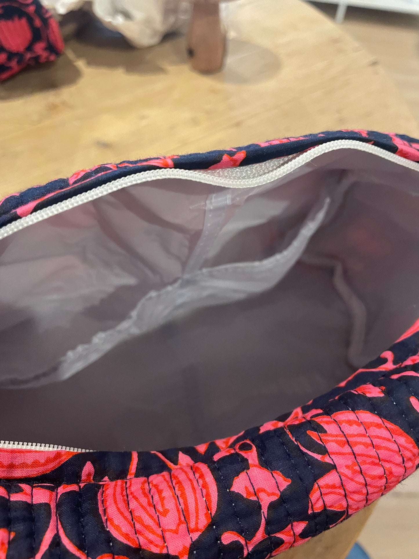 Praktische blaue Kulturtasche im Ripp-Design mit rosa/ roten Blumen. Innen mit einem wasserfesten Bezug und zwei kleinen Fächern!