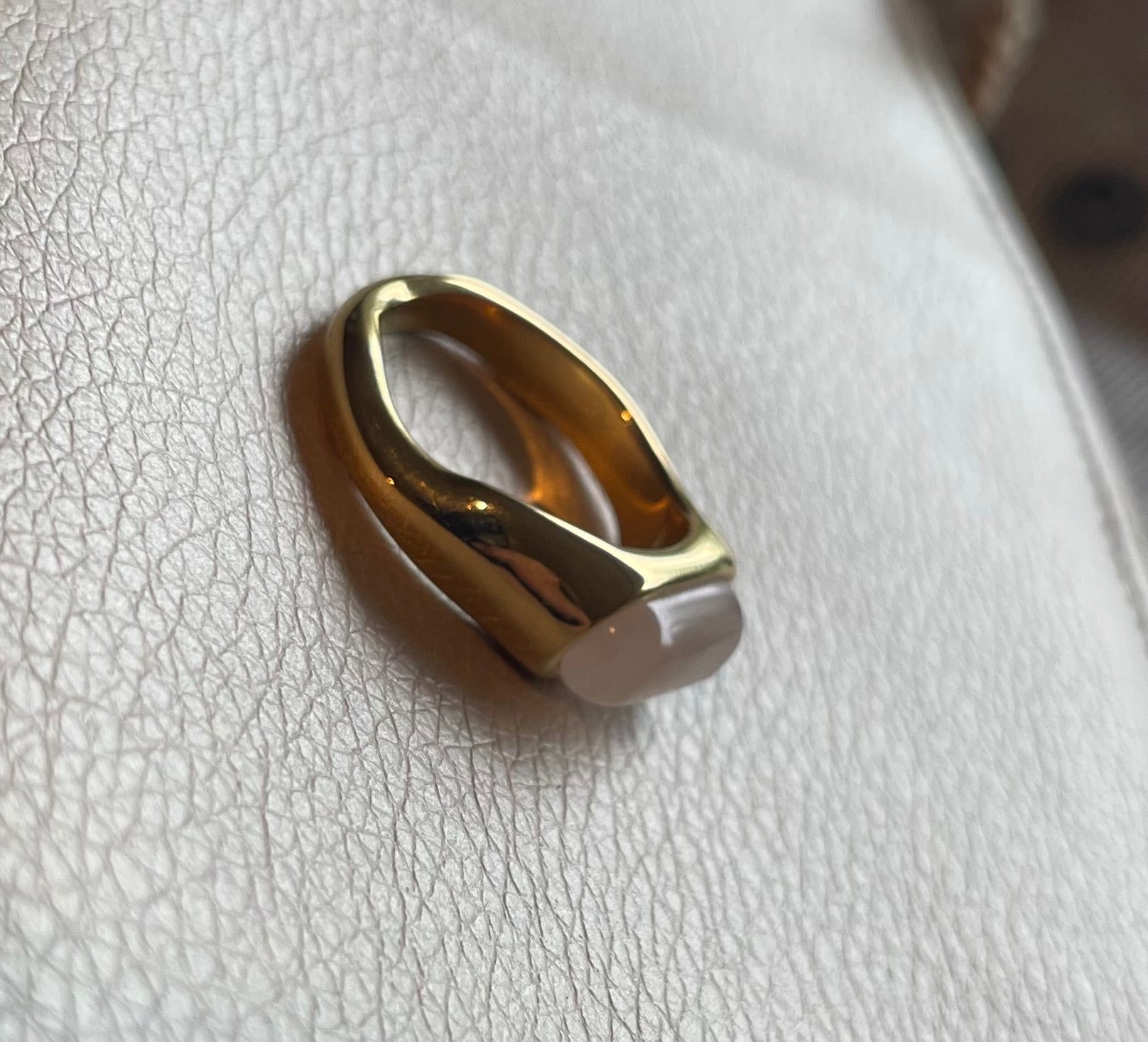 Edelstahl Ring in gold mit milchig schimmernden Stein in weiß, beige und creme.