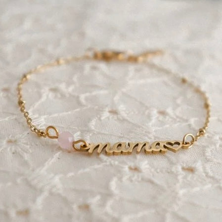 Gold Edelstahl Armband mit Mama Schriftzug und Charm Herz auf Hochglanzpoliert. Ein Rosenquarz im Facettenschliff ist angehängt !