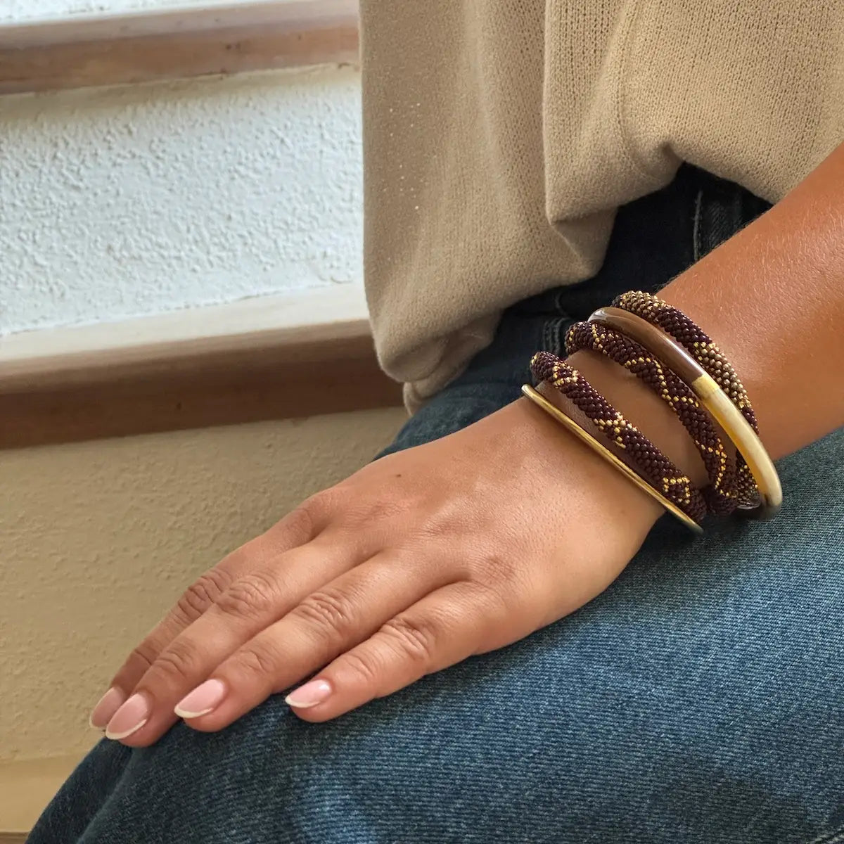 Glasperlenarmband in Braun, Gold und Bronze kombiniert mit Gold Armreif im Layering Look.